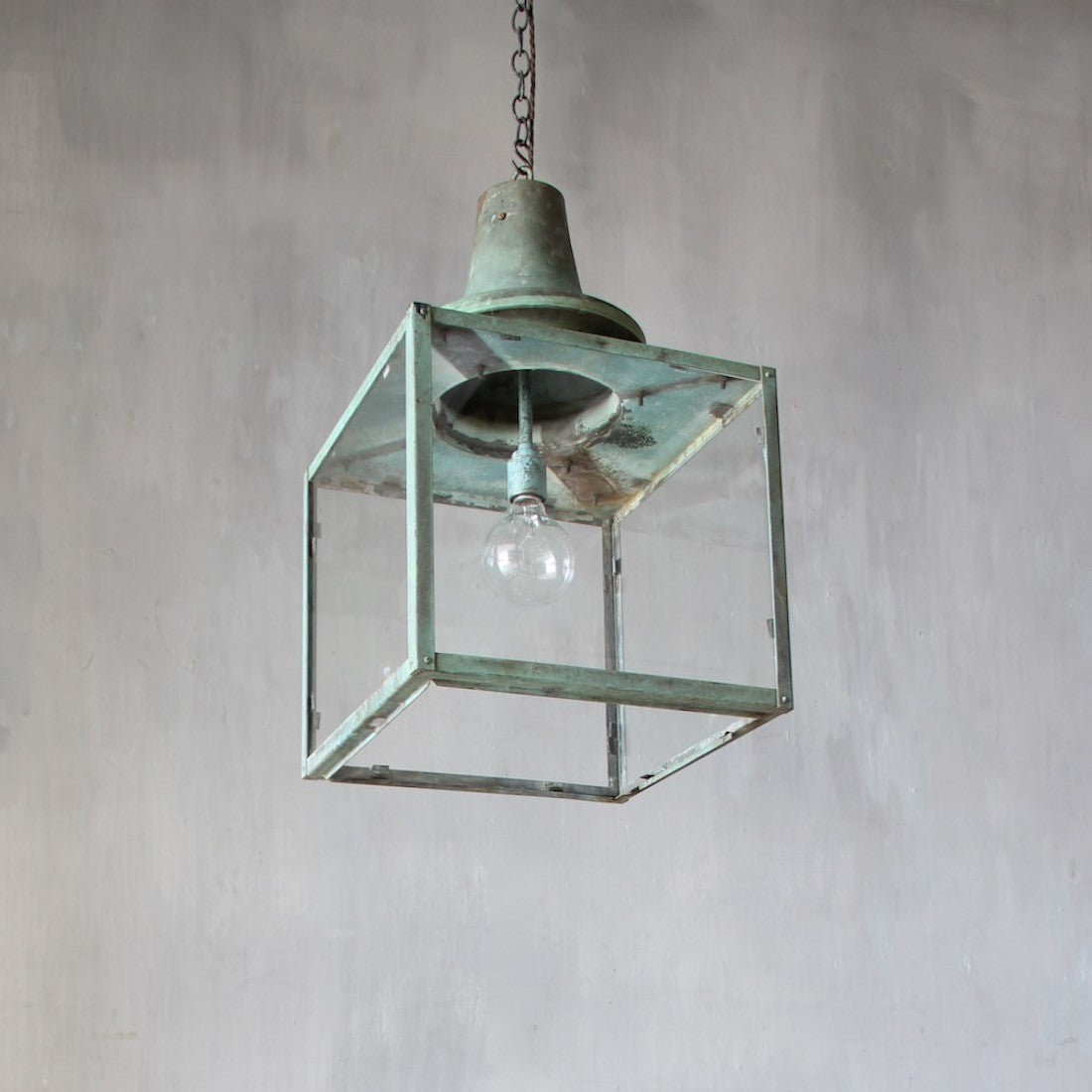 A set of three verdigris copper lanterns