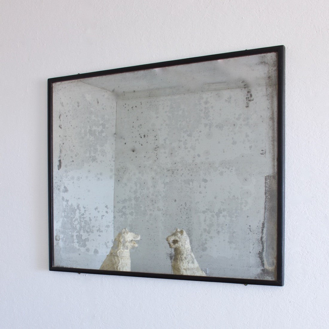 An ebonised shop mirror