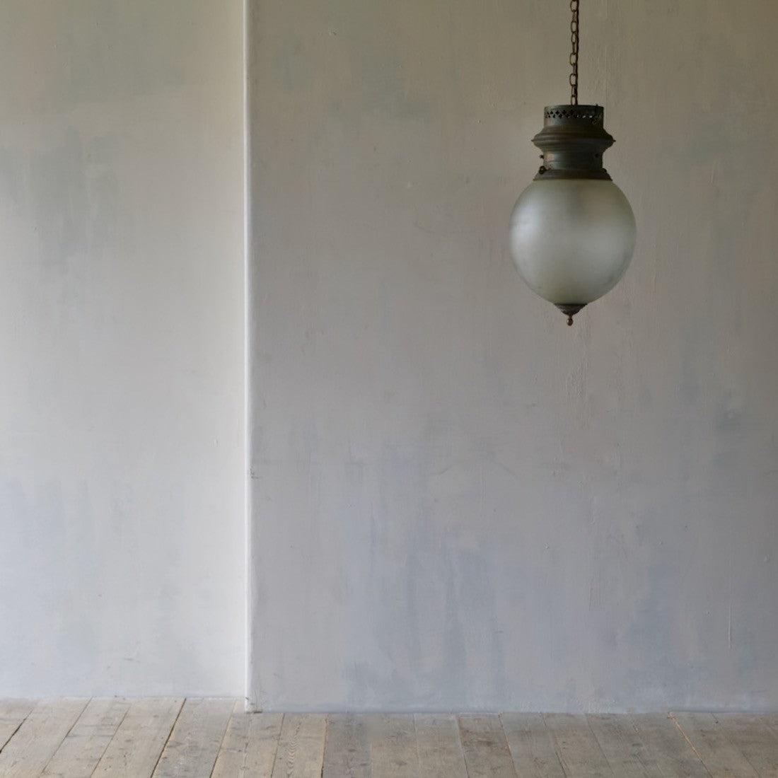 A large glass globe pendant light