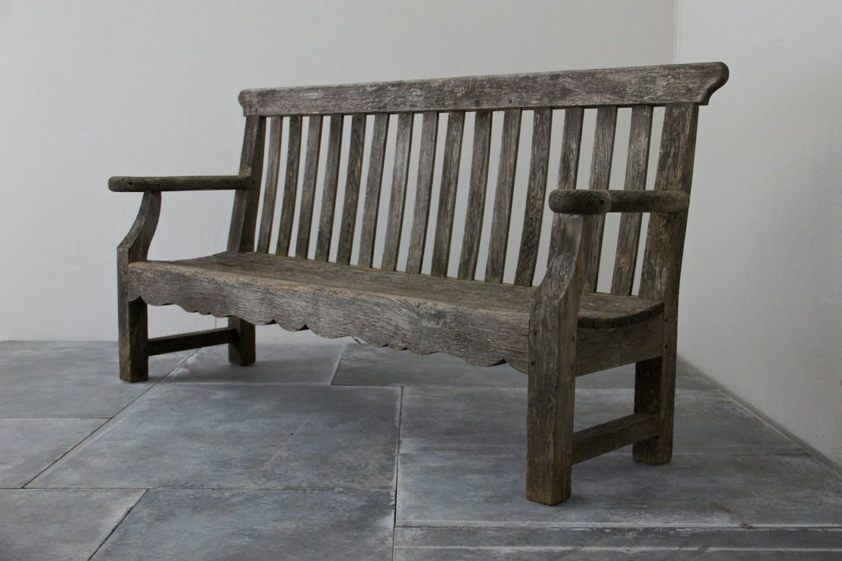 A 1920s English oak garden bench