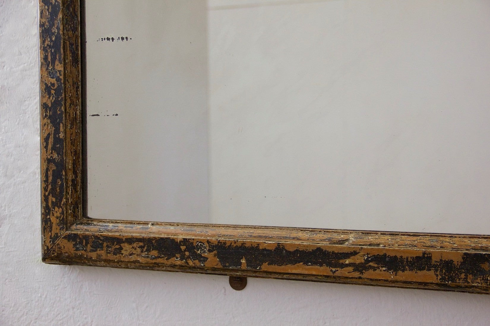 A mid c19th ebonised shop mirror