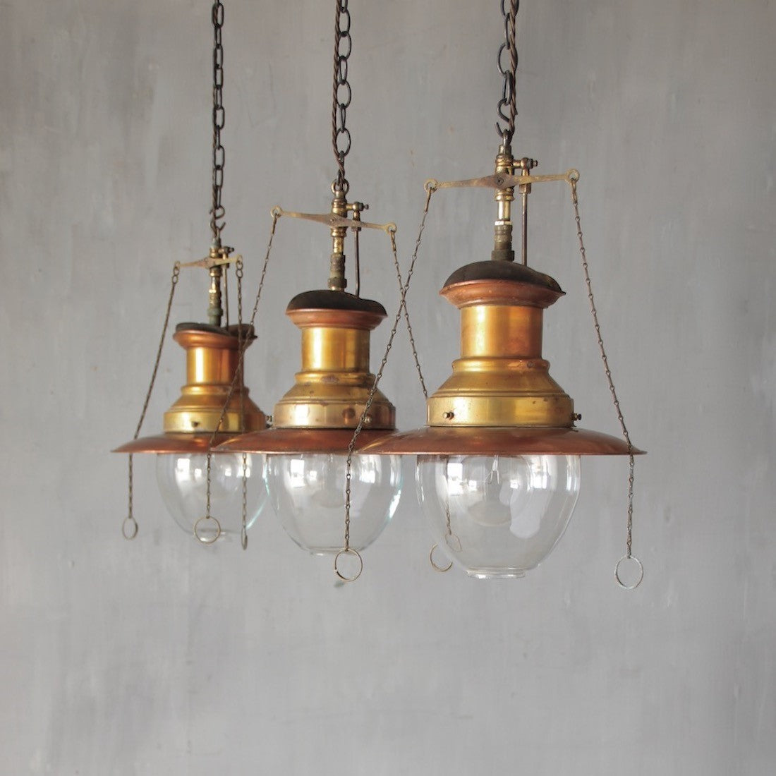 A set of three original gas pendant lights