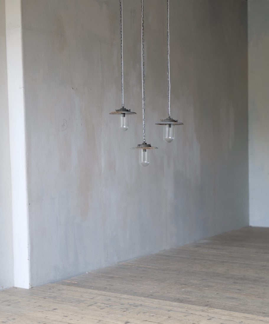 A set of three industrial pendant lights