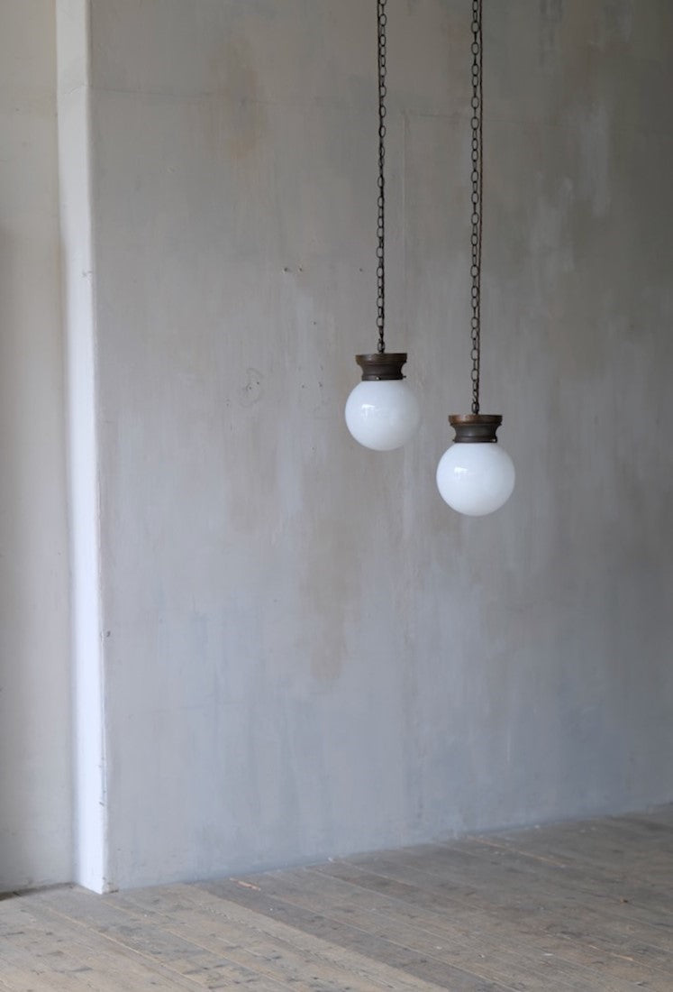 A pair of globe pendant lights