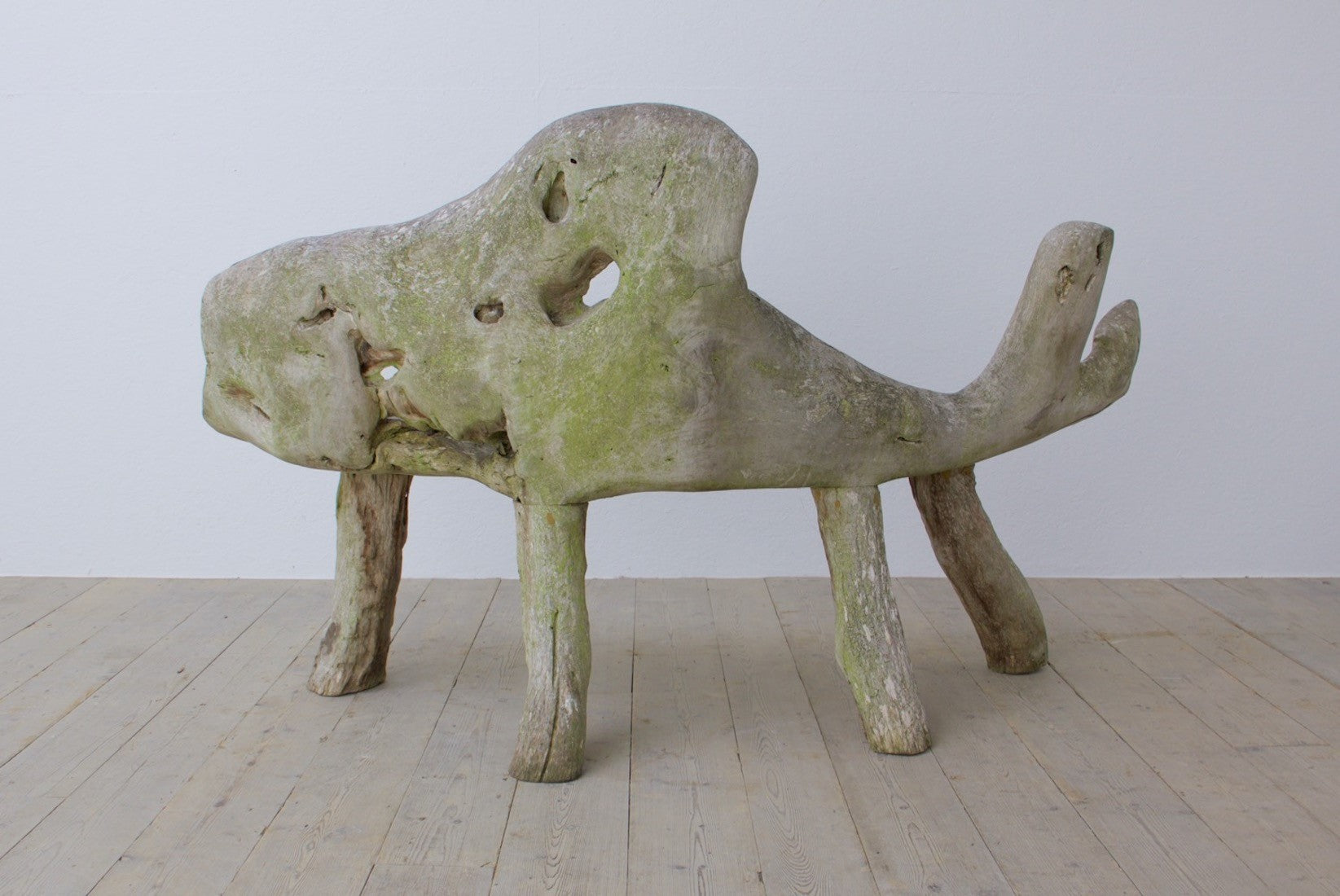 A sculptural teak bench