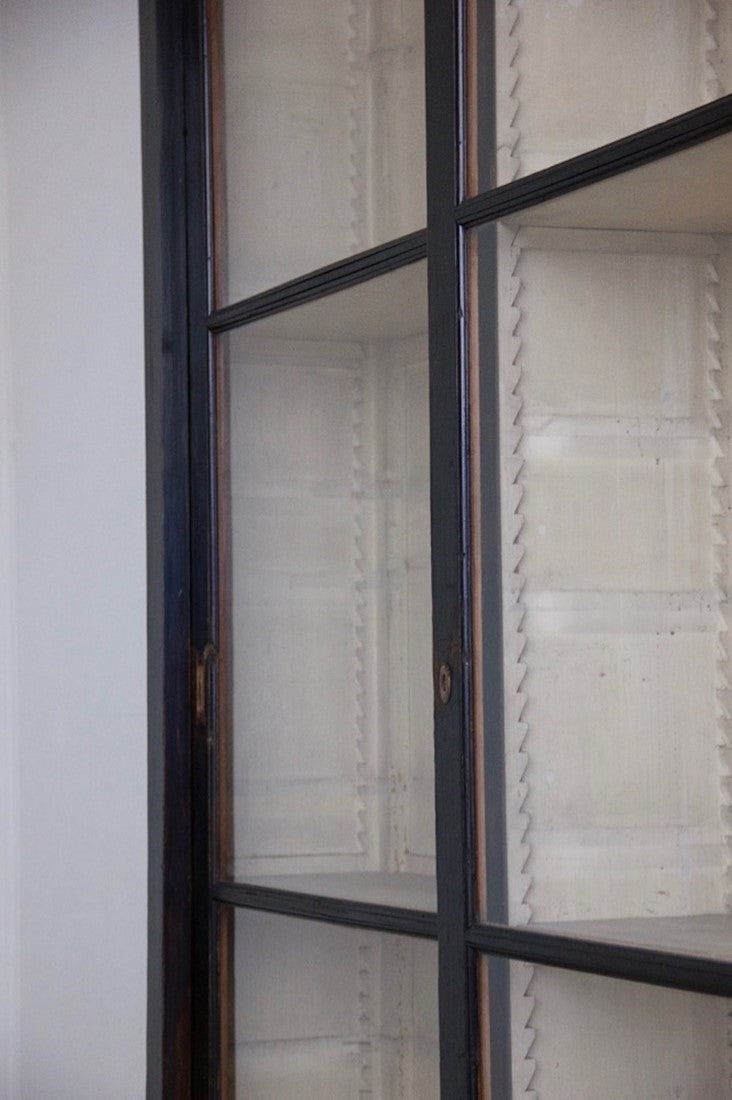An ebonised sliding door cabinet