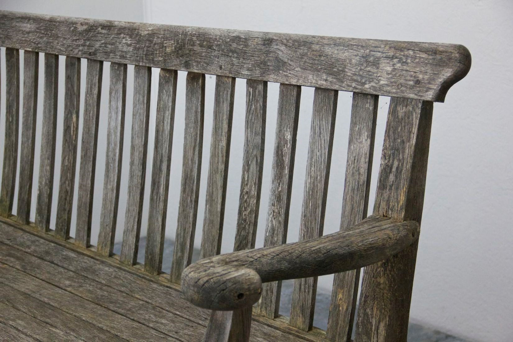 A 1920s English oak garden bench