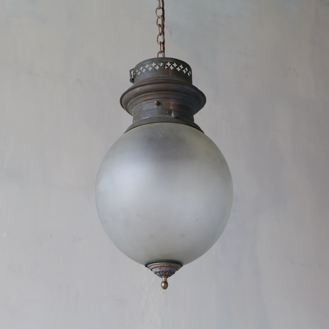 A large glass globe pendant light