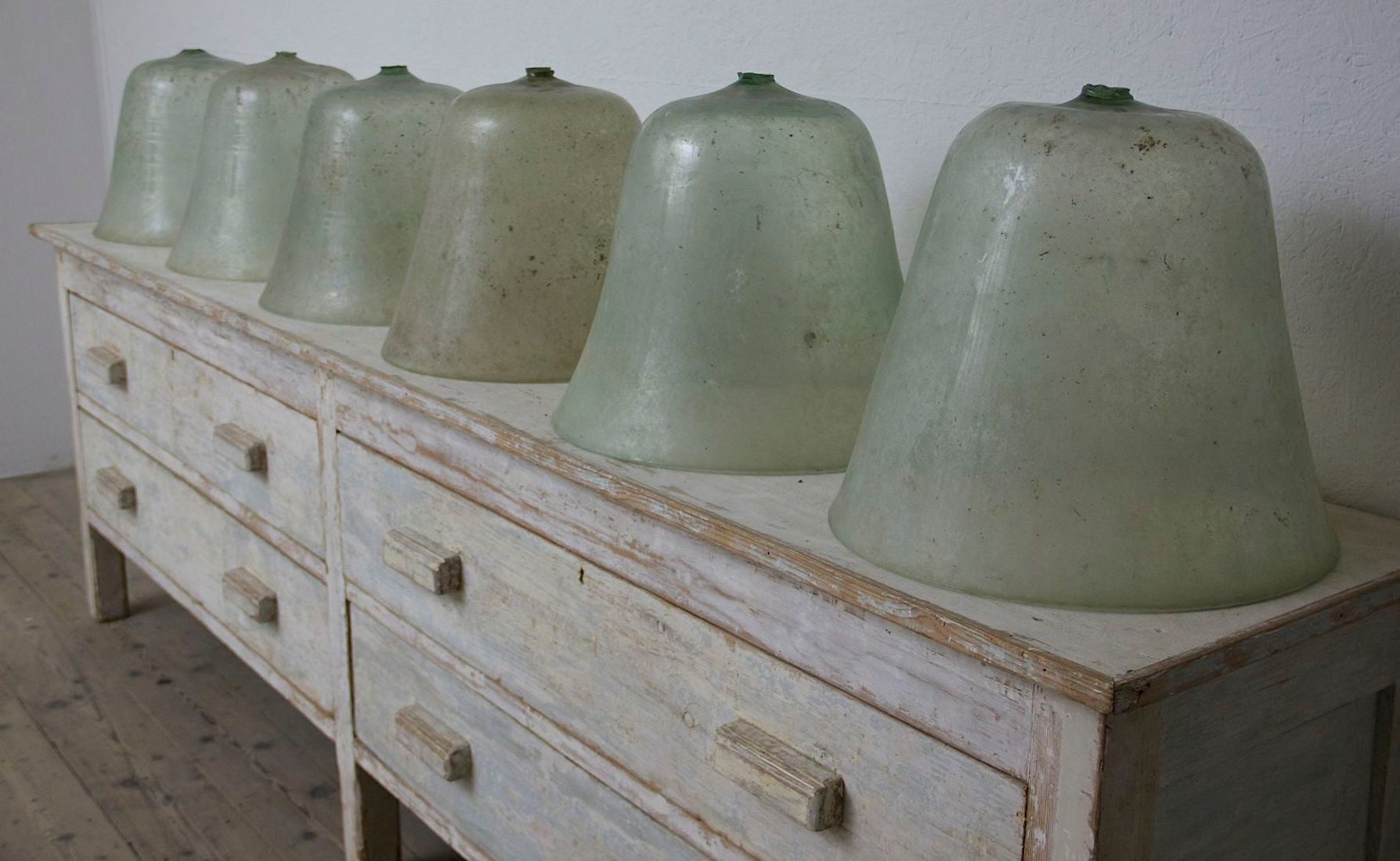 8 large early C20th melon cloches