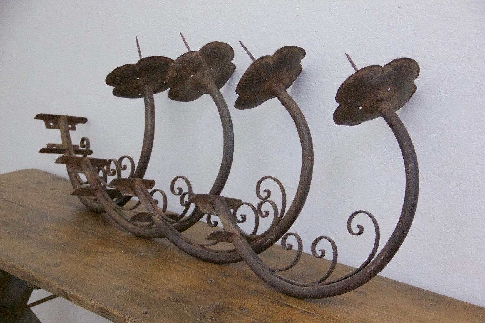 A set of 4 iron wall prickets