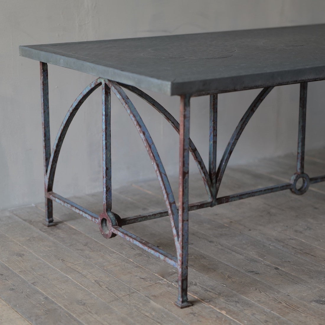 An architectural iron and zinc dining table