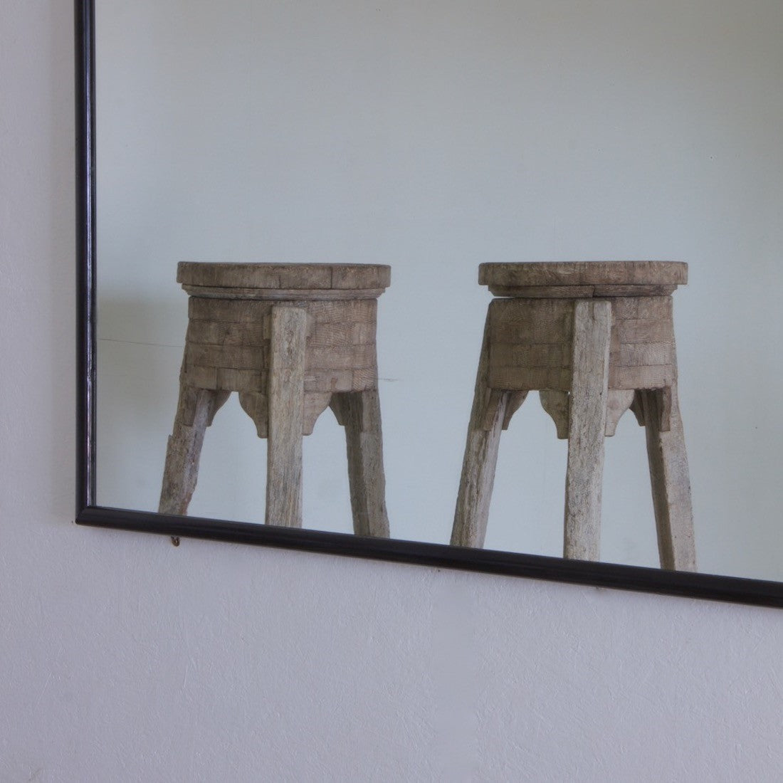 A large ebonised shop mirror