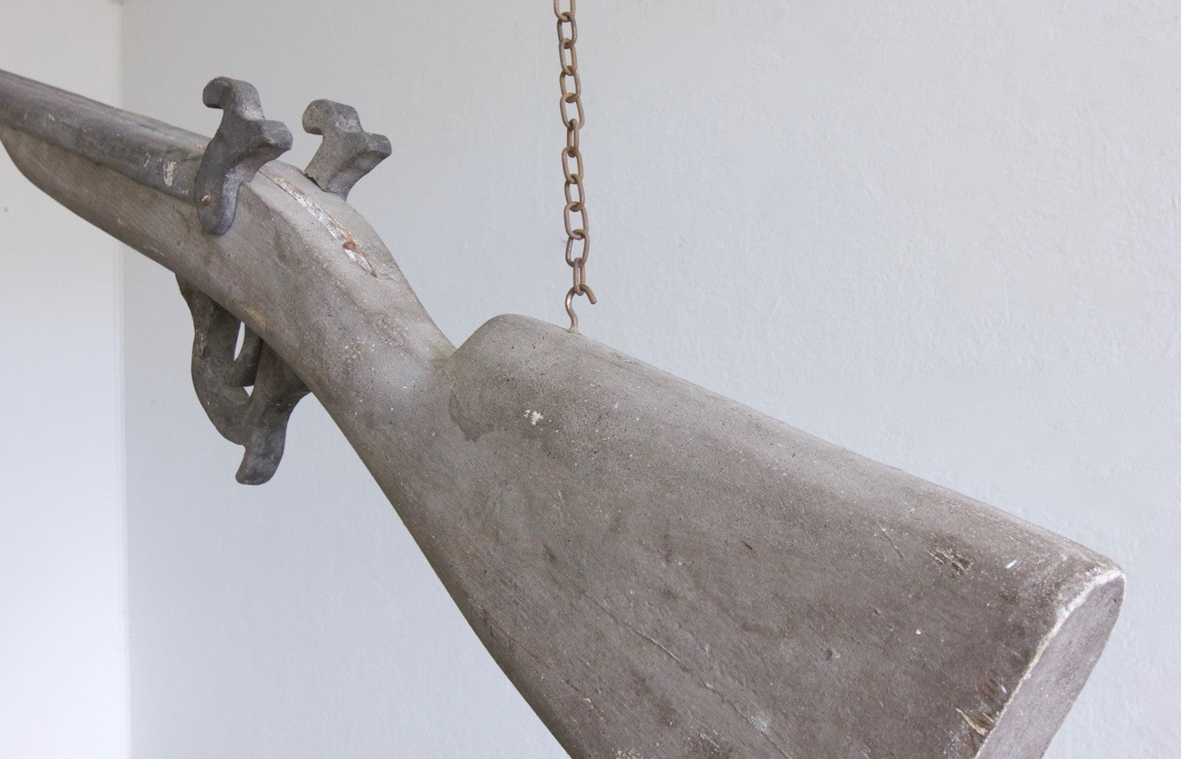 An oversized wooden model of a gun