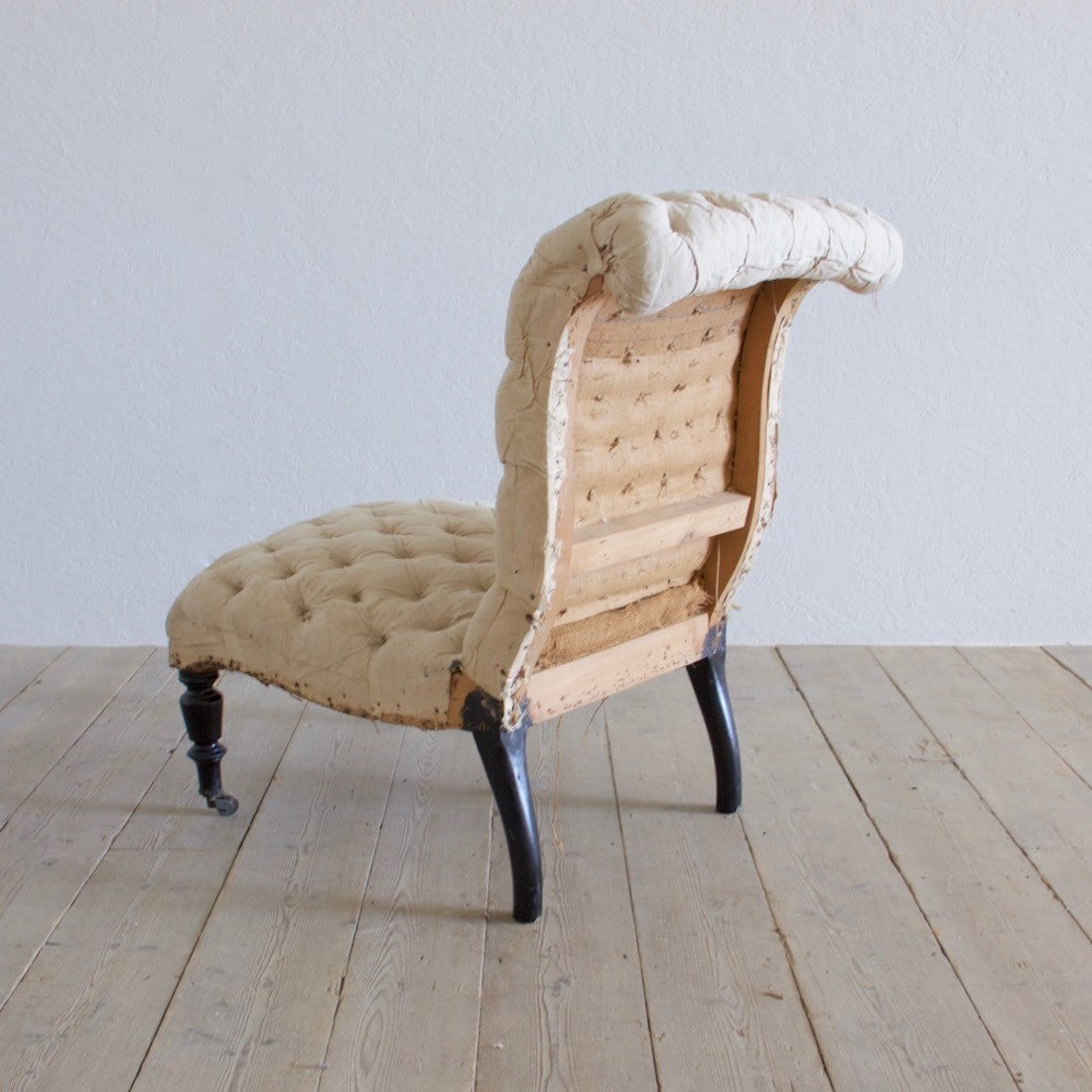 A buttoned slipper chair