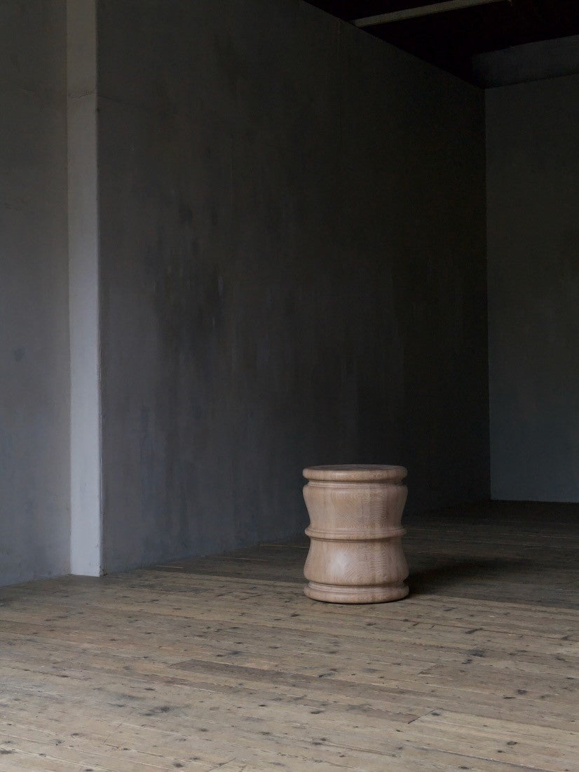 A pair of bespoke turned side tables