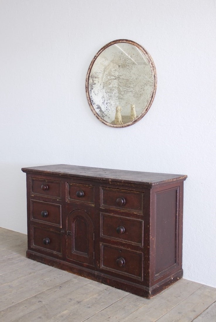 An iron-framed convex mirror