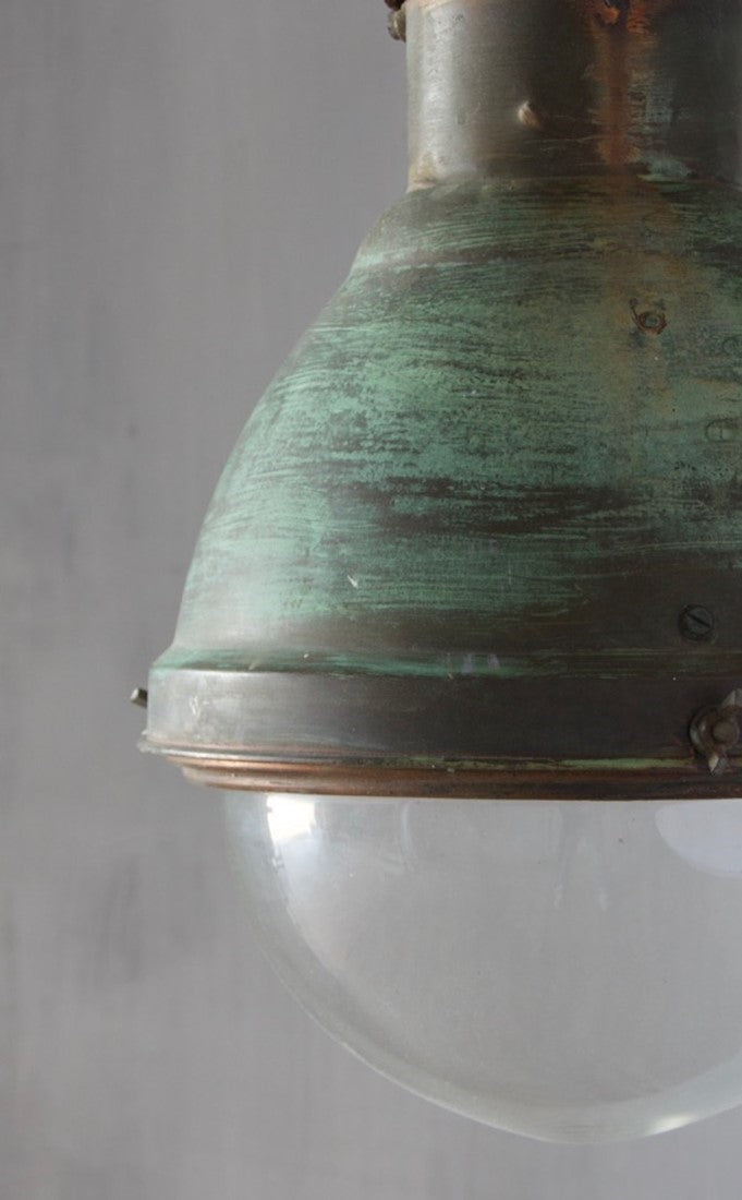 An industrial copper pendant light