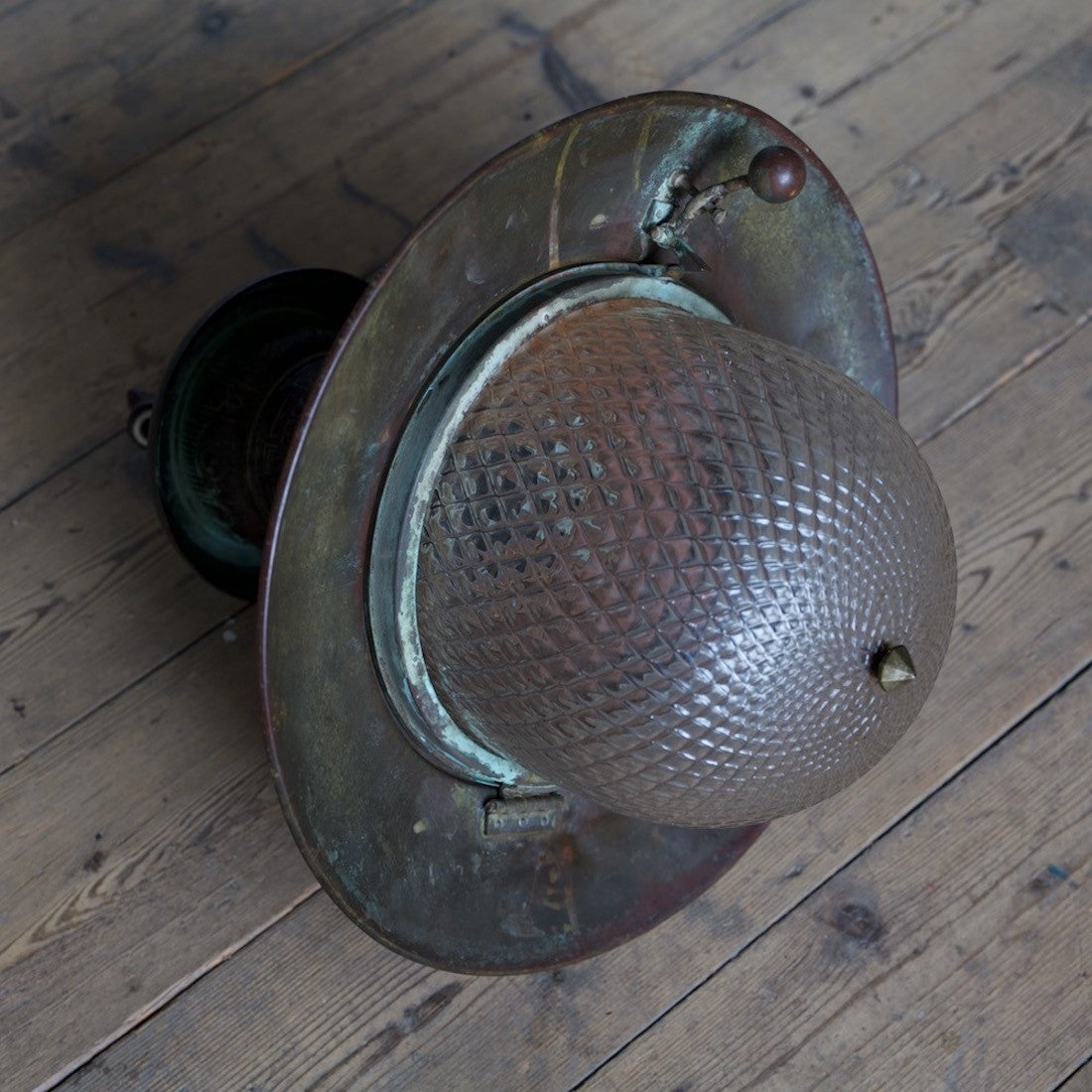 A rare copper station light with quilted glass shade