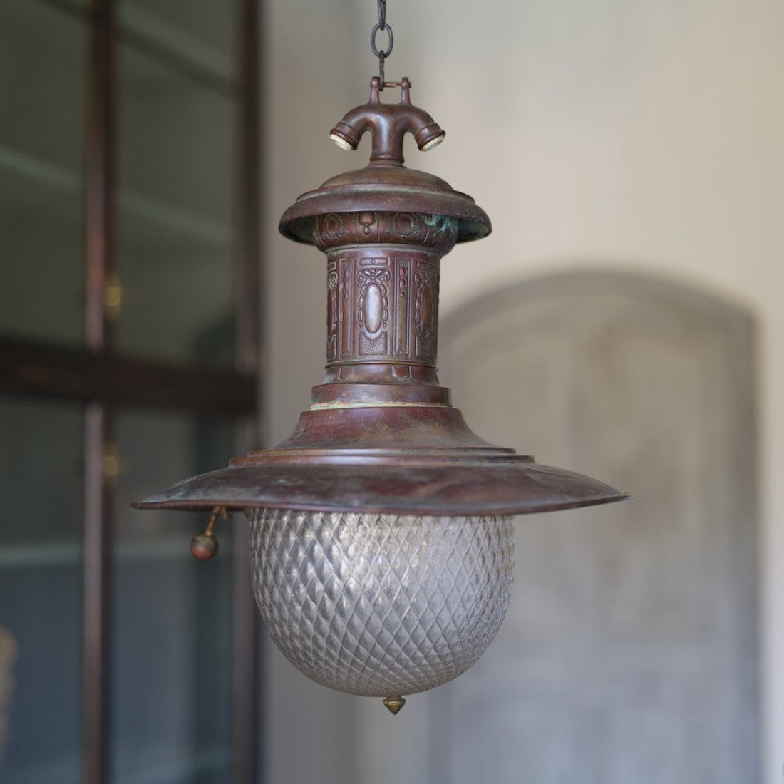 A rare copper station light with quilted glass shade