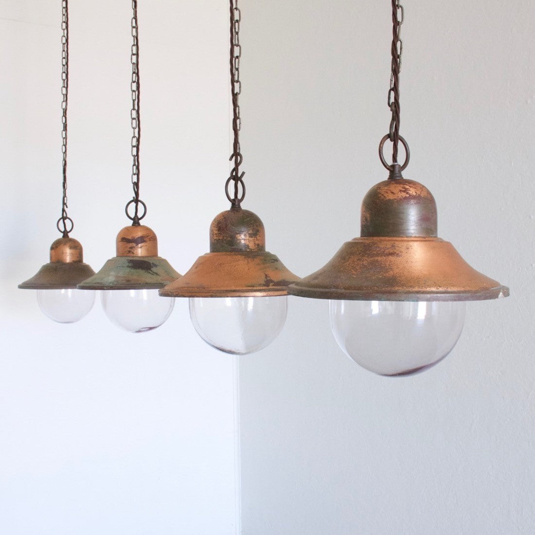 A set of 5 copper pendant lights