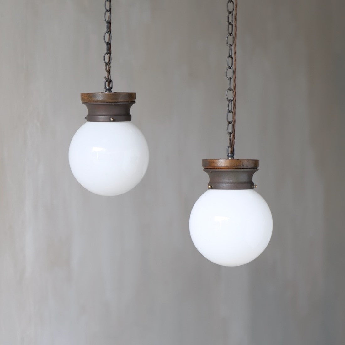 A pair of globe pendant lights