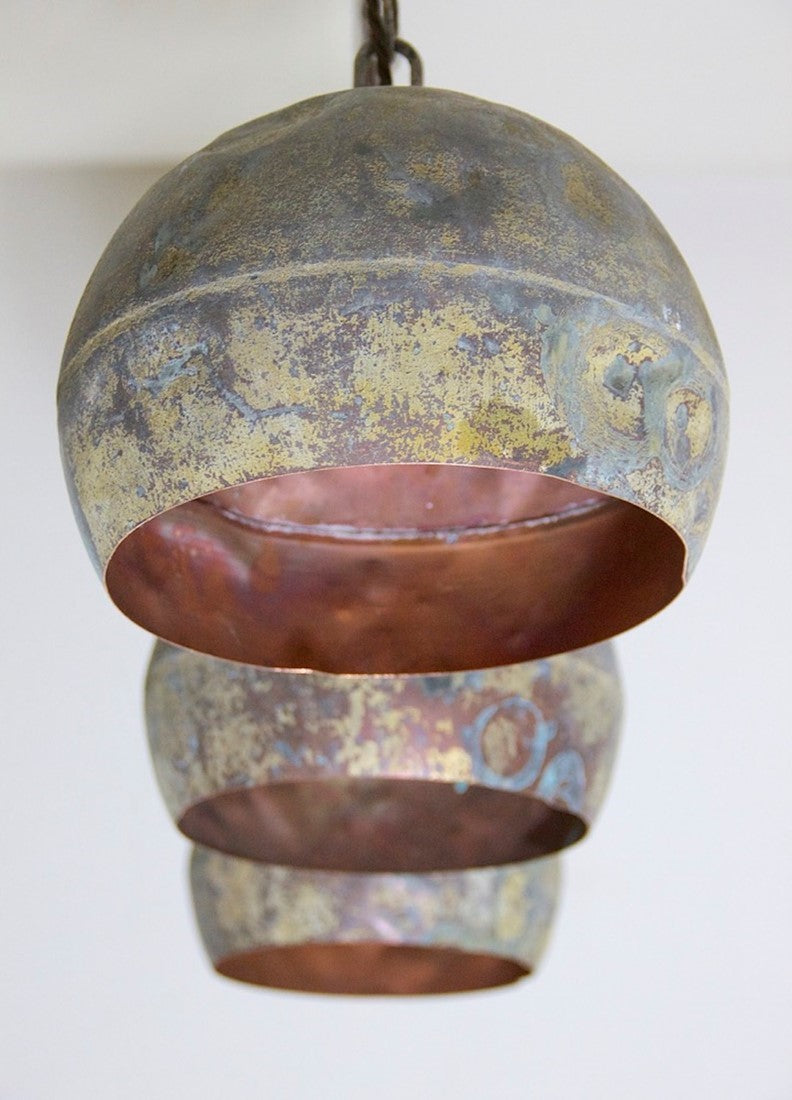 A set of three copper pendant lights