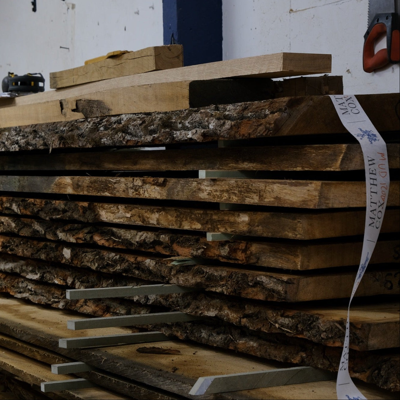 Stack of wooden planks in a workshop setting