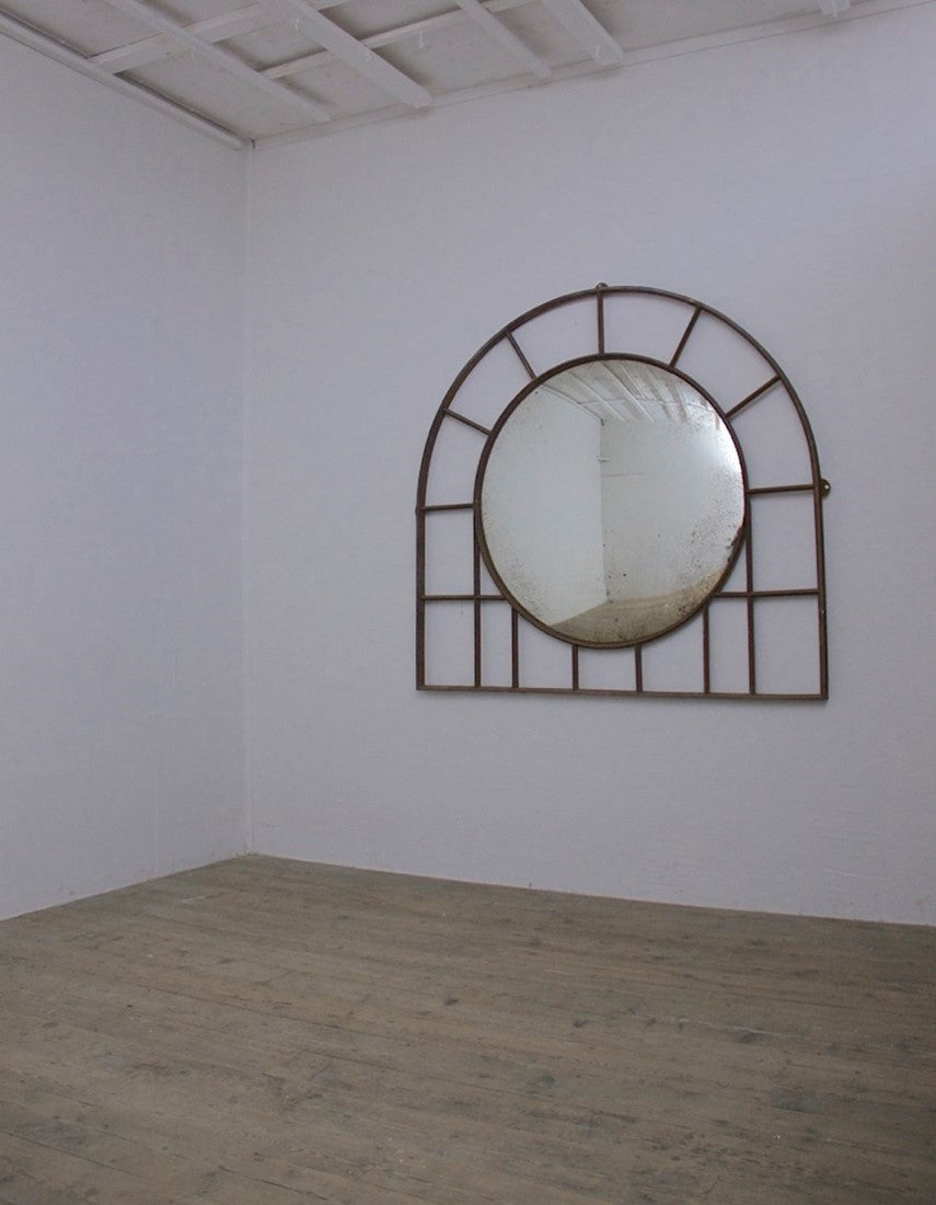 A large C19th wrought iron convex mirror