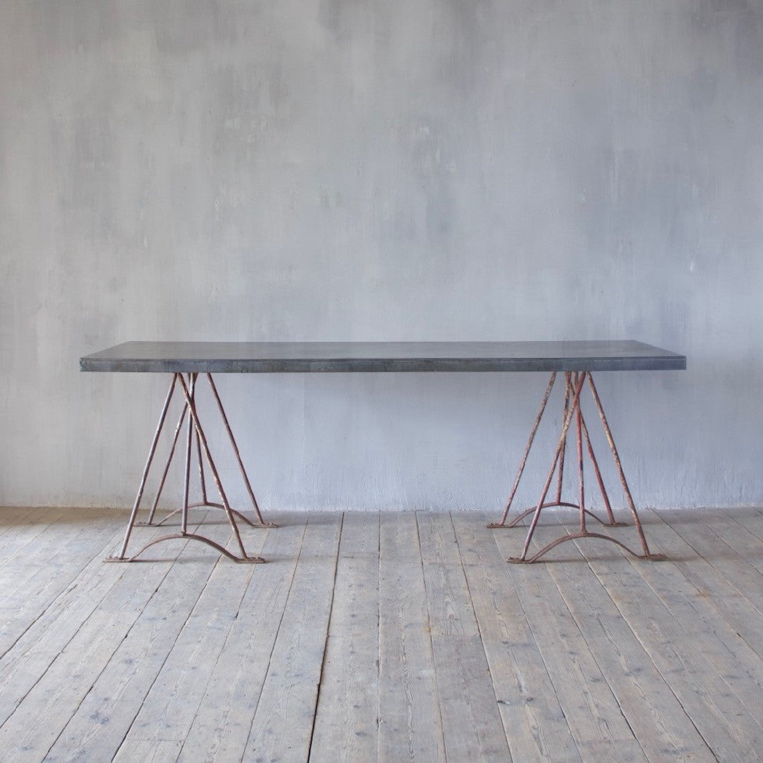 An architectural wrought iron trestle table