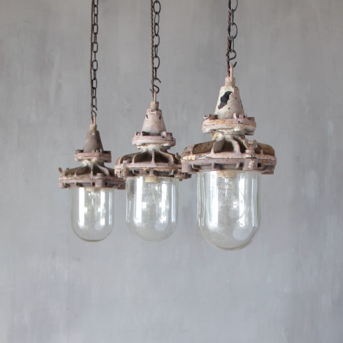 A set of three small industrial pendant lights