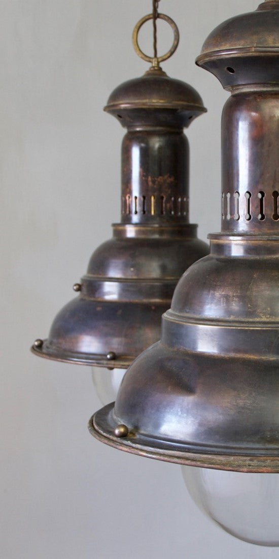 A pair of large brass pendants