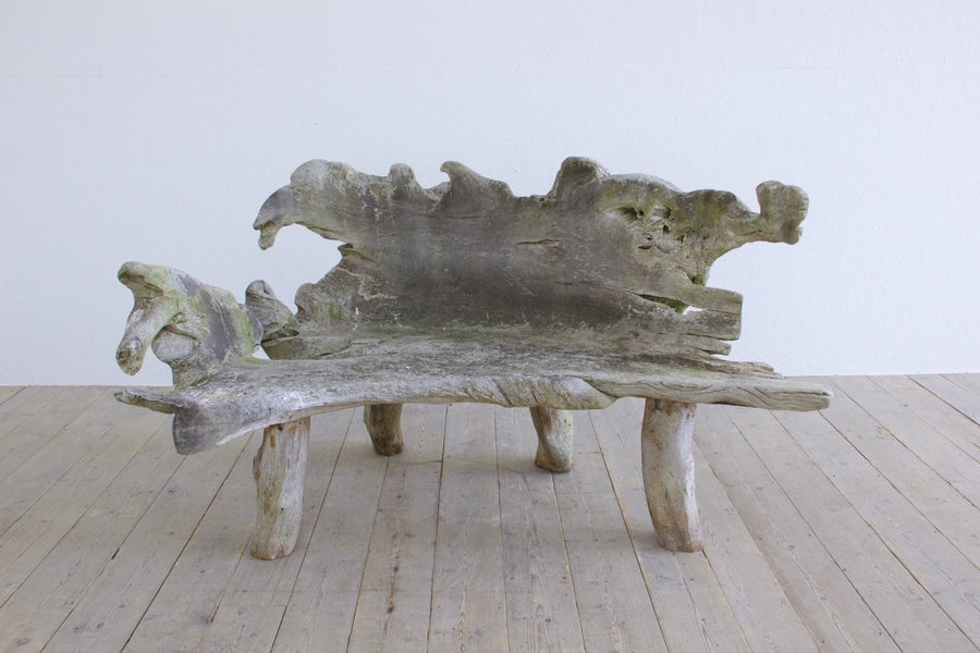 A sculptural 'splash' teak bench