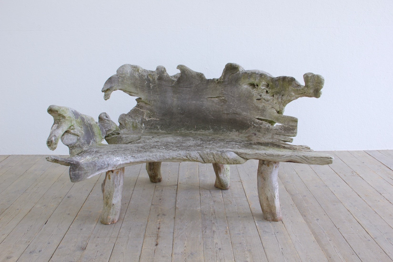 A sculptural 'splash' teak bench