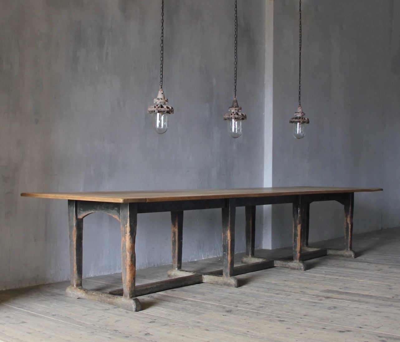 A set of three small industrial pendant lights