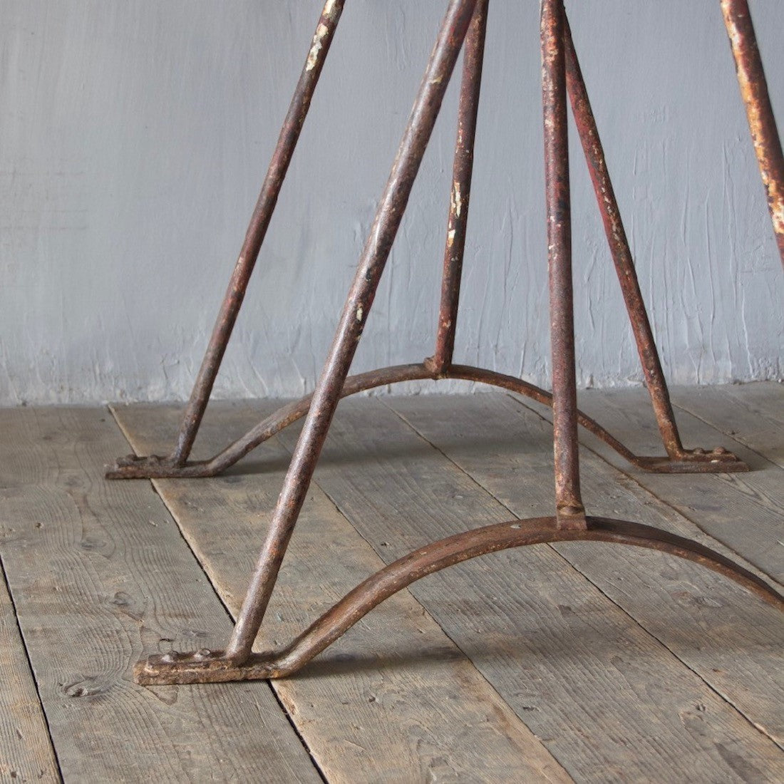 An architectural wrought iron trestle table