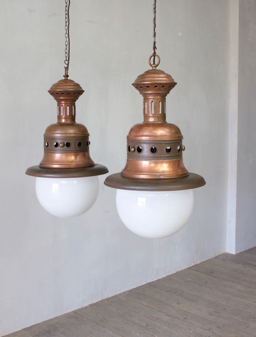 A pair of large copper pendants