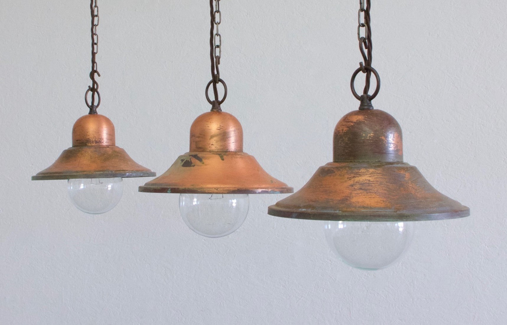 A set of 3 copper pendant lights