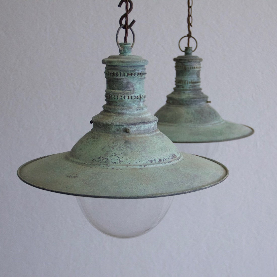 A pair of verdigris copper pendant lights