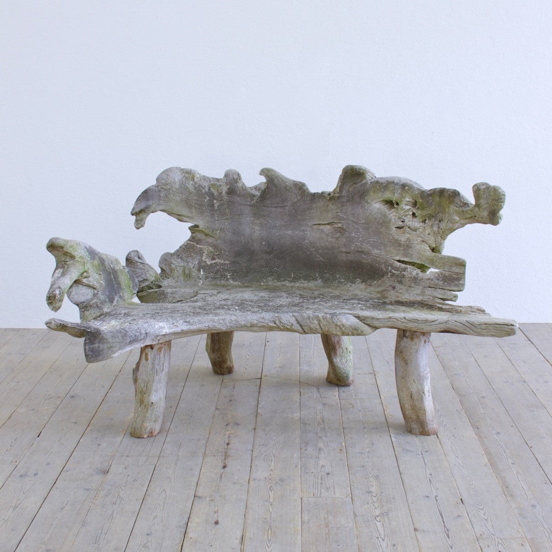 A sculptural 'splash' teak bench
