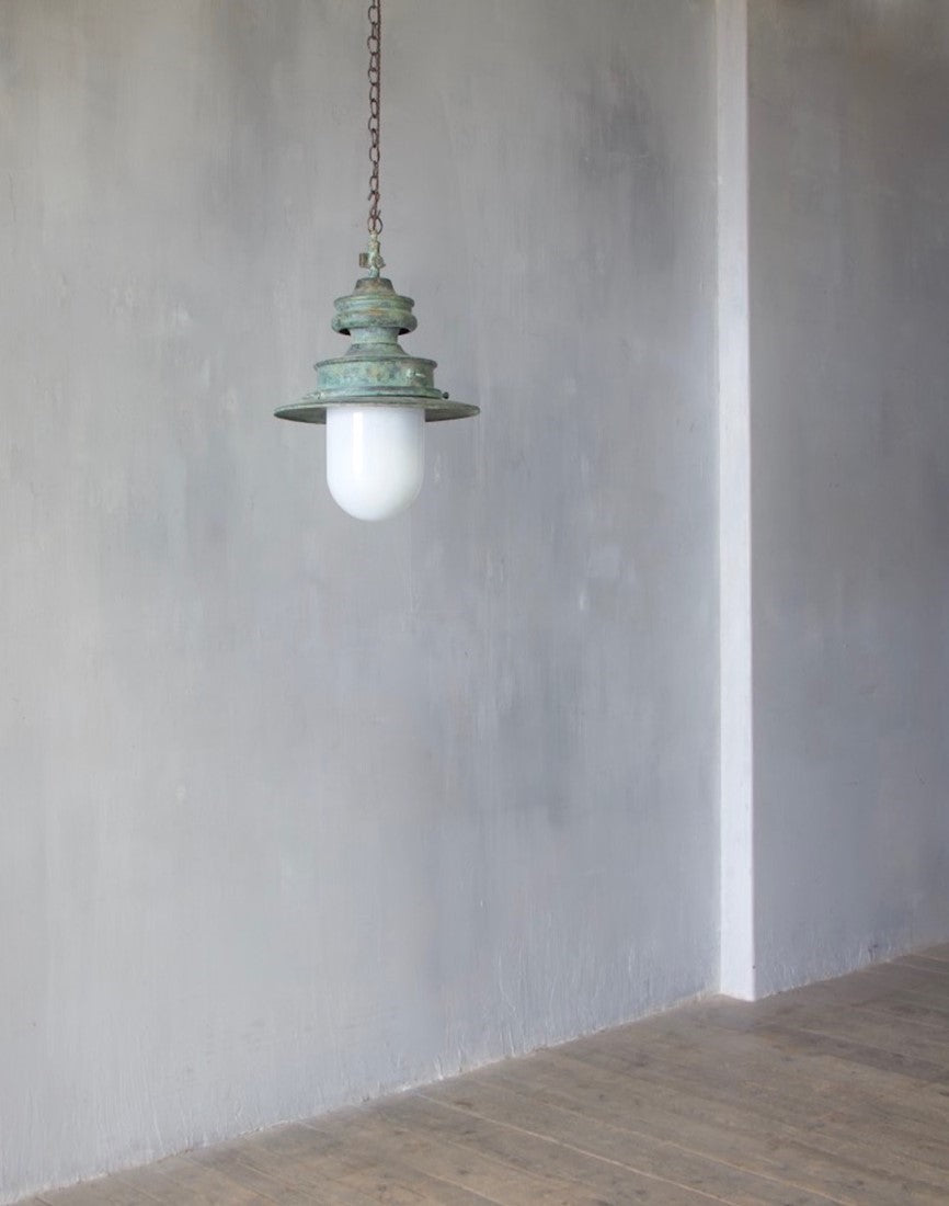 A verdigris copper station light