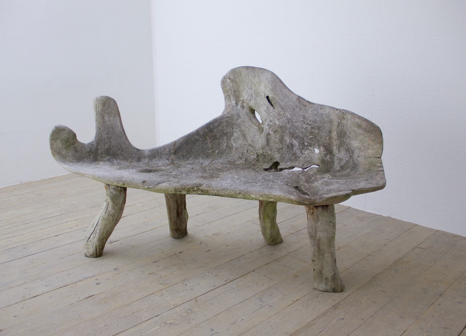 A sculptural teak bench
