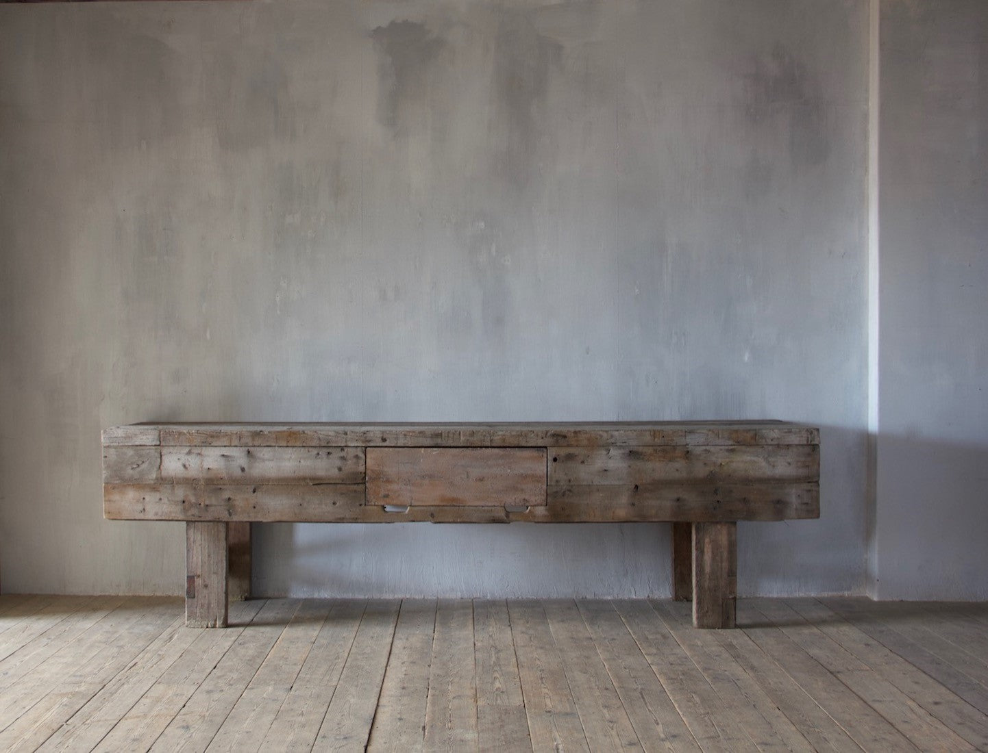 A large weathered work table
