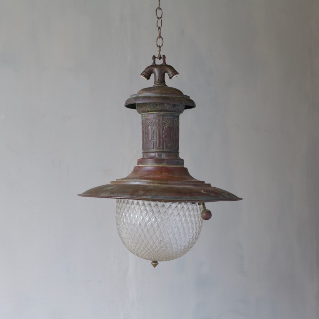 A rare copper station light with quilted glass shade