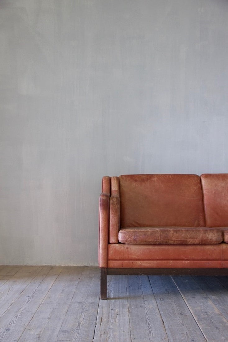A mid-century red leather sofa