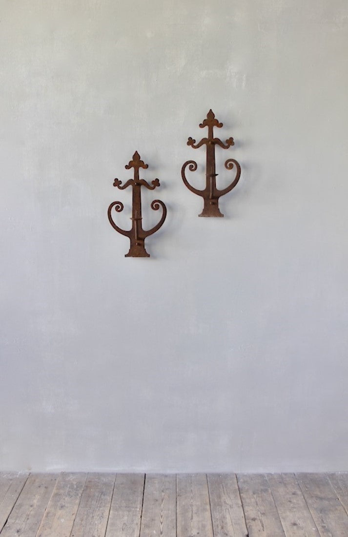 A pair of wrought iron sconces