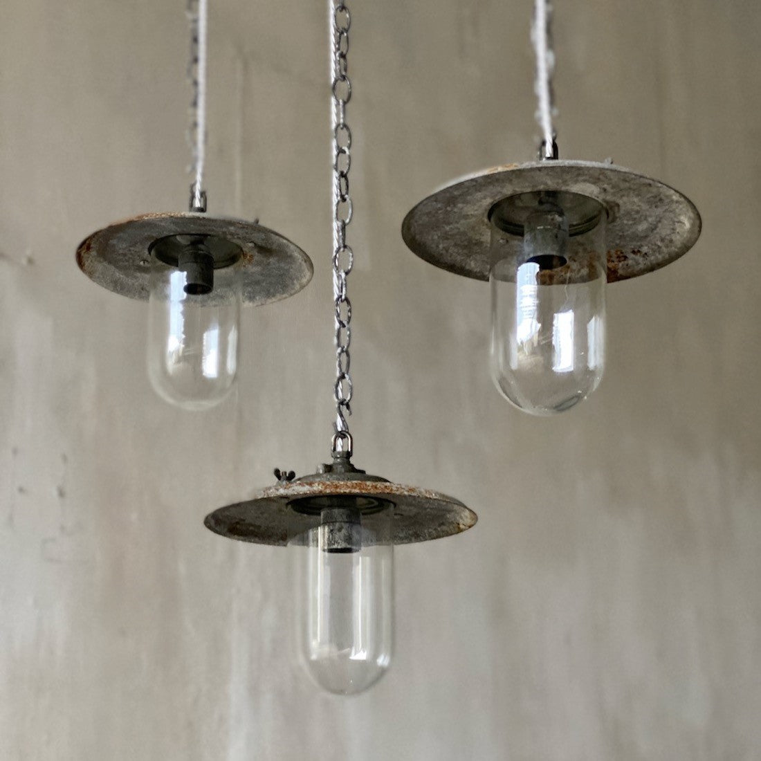 A set of three industrial pendant lights