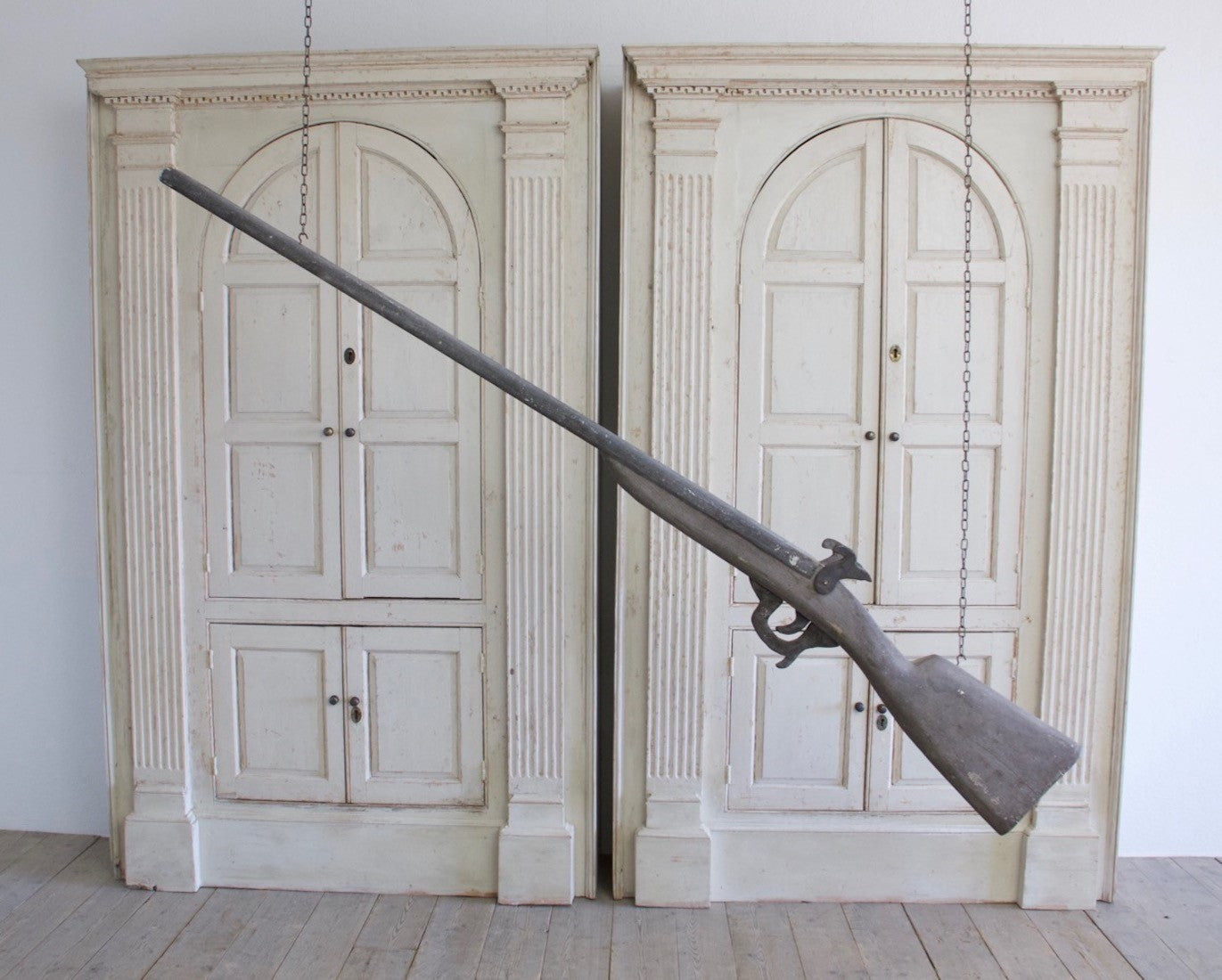 An oversized wooden model of a gun