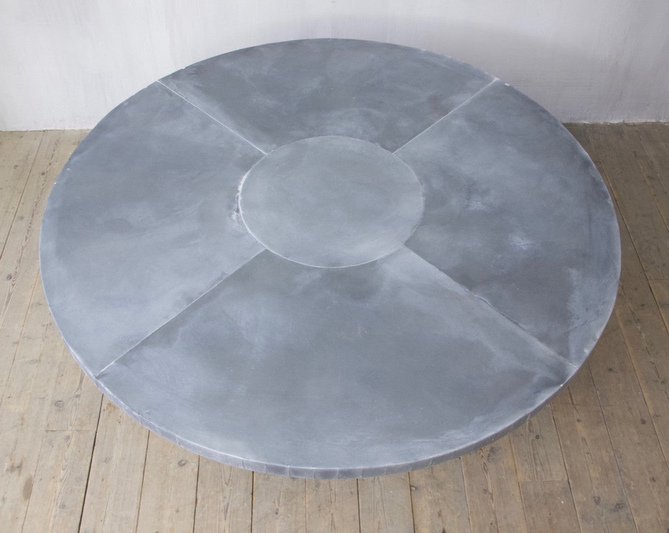 A weathered oak and zinc dining table