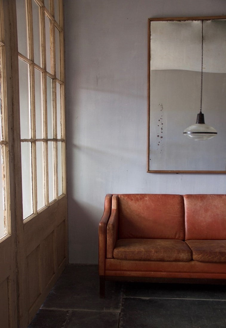 A mid-century red leather sofa