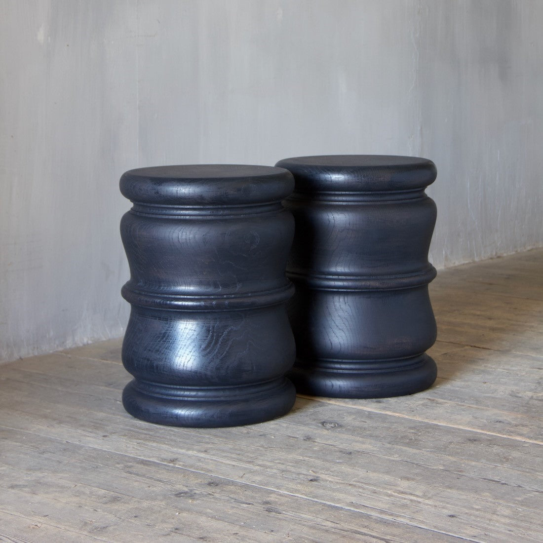 A pair of bespoke turned side tables